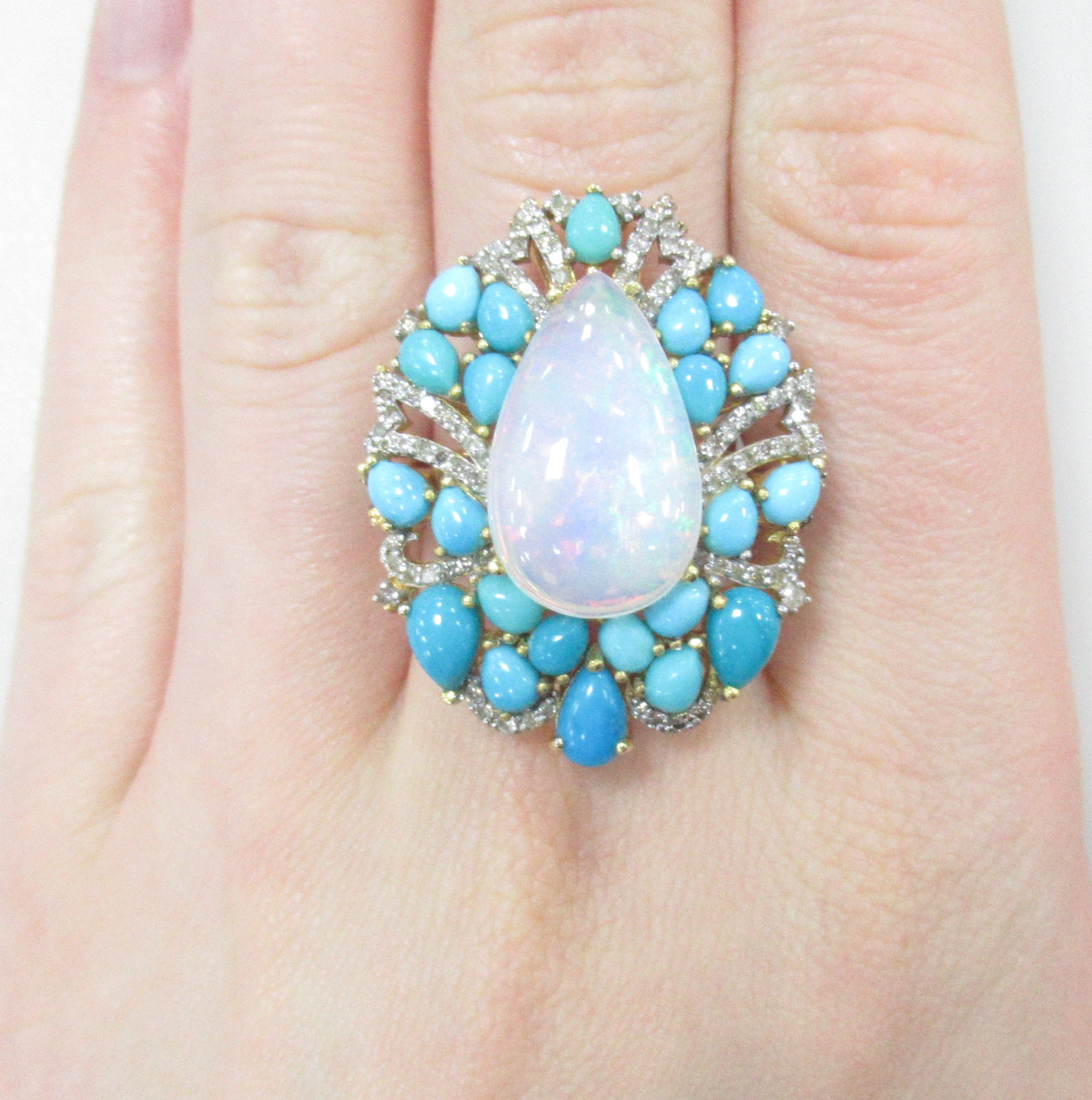 Серебряное кольцо 925 пробы; вставки 1 Опал белый (Эфиопия) 6,25ct; 118 Бр.Кр-17 0,74ct 2/4; 22 Бирюза 4,51ct;